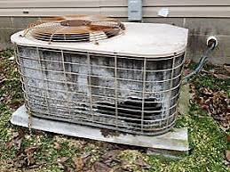 A heavily neglected outdoor AC condenser — clogged, corroded, and overworked